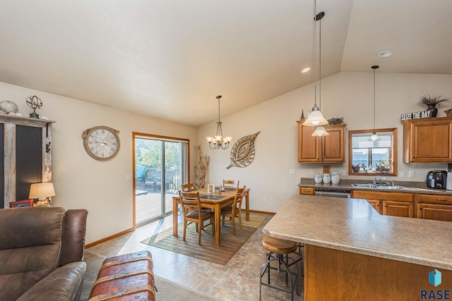 kitchen featuring vaulted ceiling, an inviting chandelier, pendant lighting, a breakfast bar, and sink