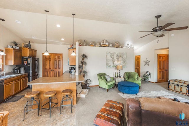 living room featuring light carpet, lofted ceiling, sink, and ceiling fan