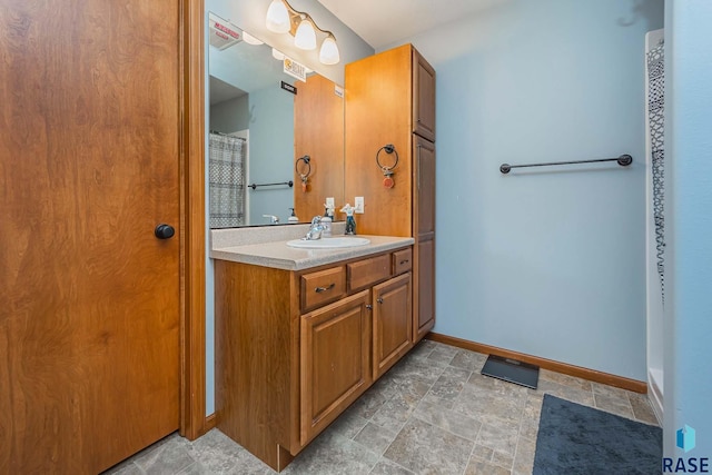 bathroom featuring vanity and a shower with shower curtain