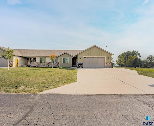 ranch-style house featuring a garage and a front lawn