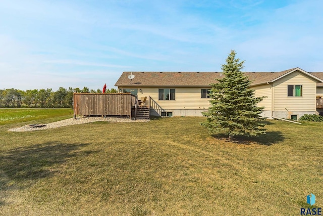 rear view of house featuring a yard