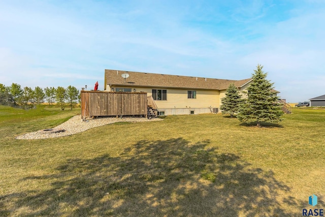 rear view of property with a lawn