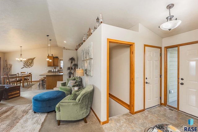 entrance foyer featuring vaulted ceiling and a chandelier