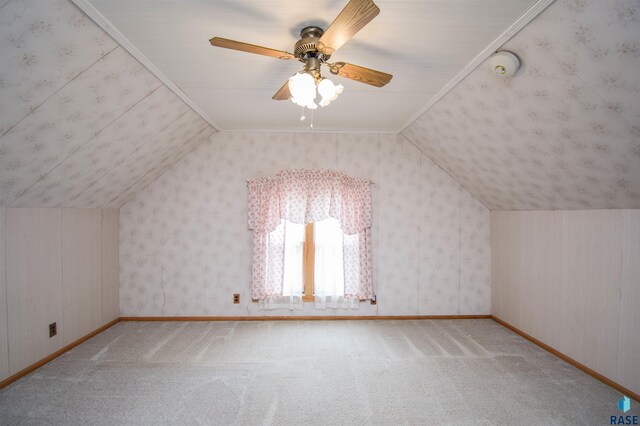 additional living space featuring light colored carpet, lofted ceiling, and ceiling fan