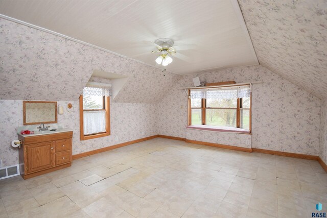 additional living space with lofted ceiling, plenty of natural light, and ceiling fan