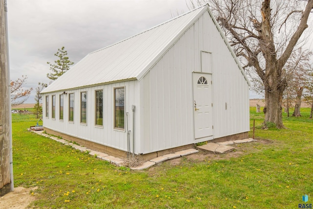 view of outbuilding featuring a lawn