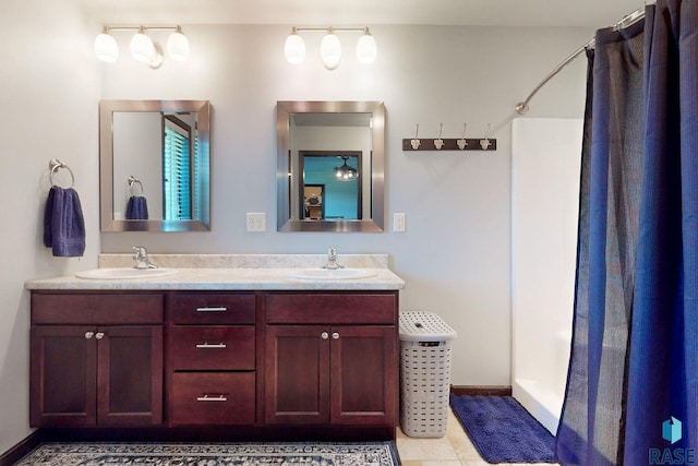 bathroom with tile patterned flooring, vanity, and curtained shower