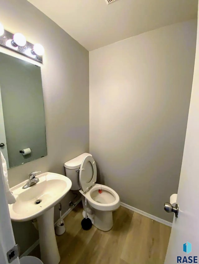 bathroom featuring toilet and hardwood / wood-style floors