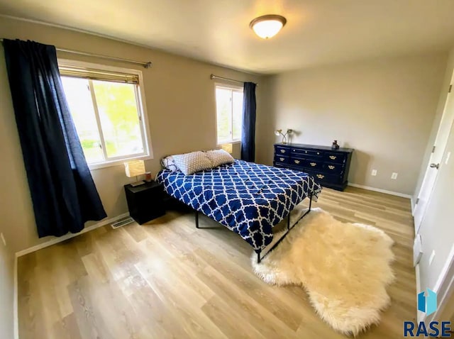 bedroom with light wood-type flooring