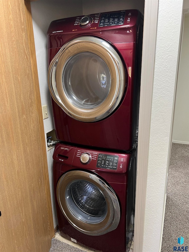 washroom featuring stacked washer and dryer