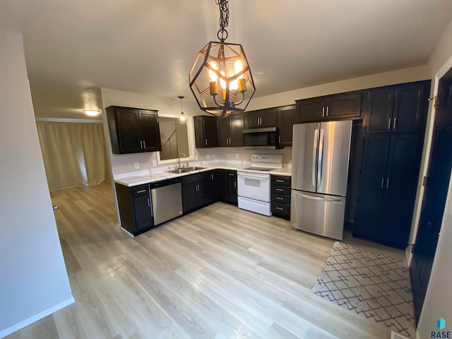 kitchen with sink, decorative light fixtures, light hardwood / wood-style floors, and stainless steel appliances