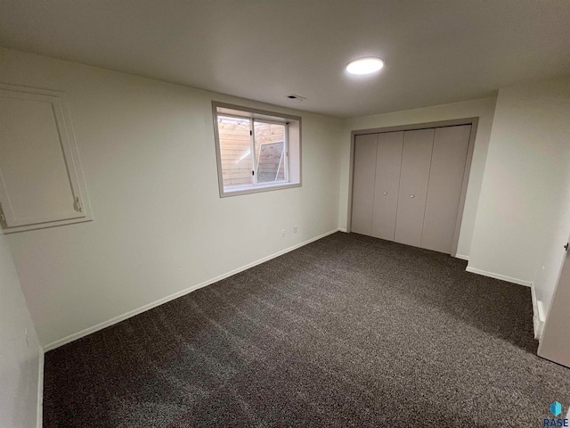 unfurnished bedroom featuring carpet and a closet