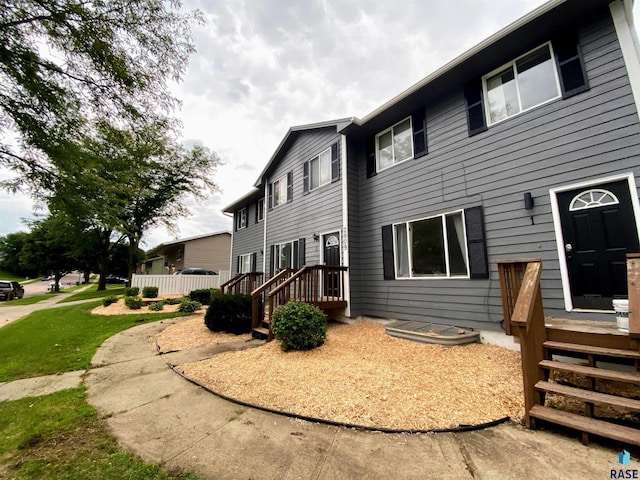 rear view of house featuring a wooden deck