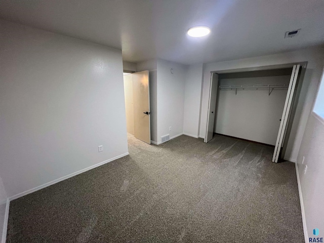 unfurnished bedroom featuring a closet and carpet