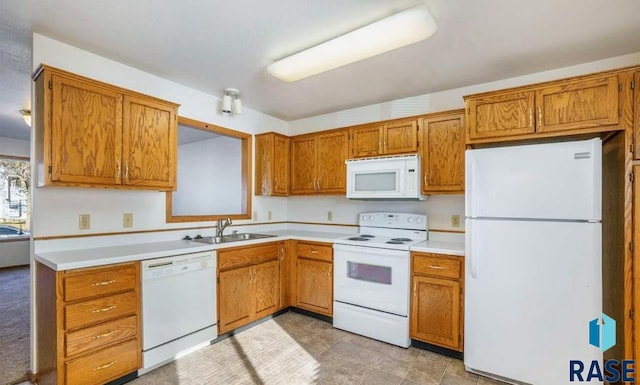 kitchen featuring white appliances and sink