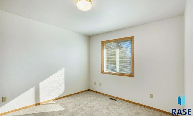 unfurnished room with light carpet