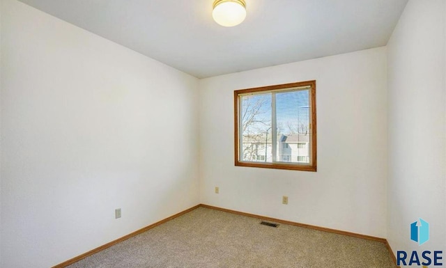 empty room featuring light carpet