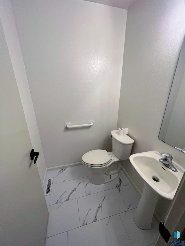 bathroom with toilet and sink