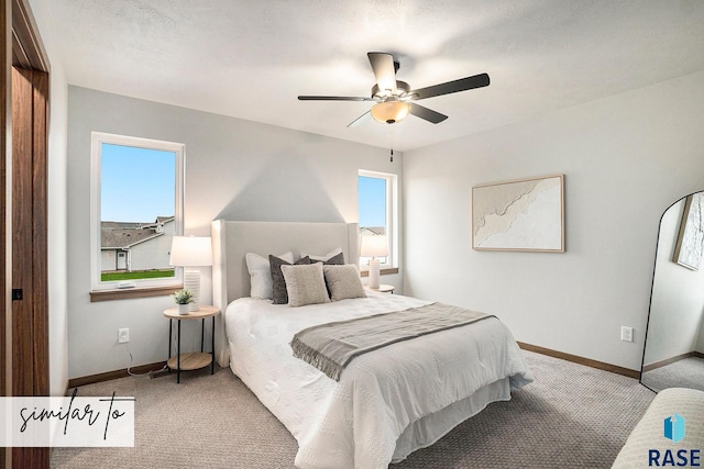 bedroom featuring multiple windows, light colored carpet, and ceiling fan