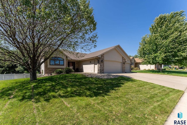 single story home with a garage and a front yard