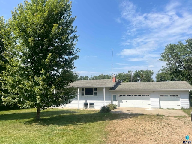 single story home with a garage and a front lawn