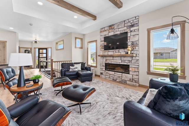 living room featuring plenty of natural light and beam ceiling