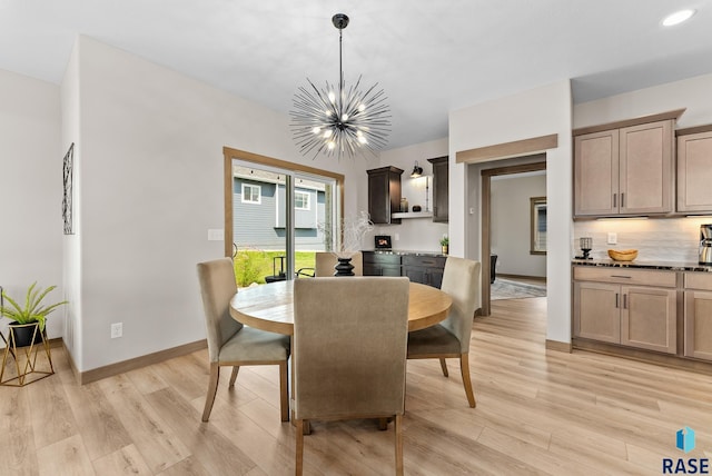 dining room with a notable chandelier and light hardwood / wood-style flooring