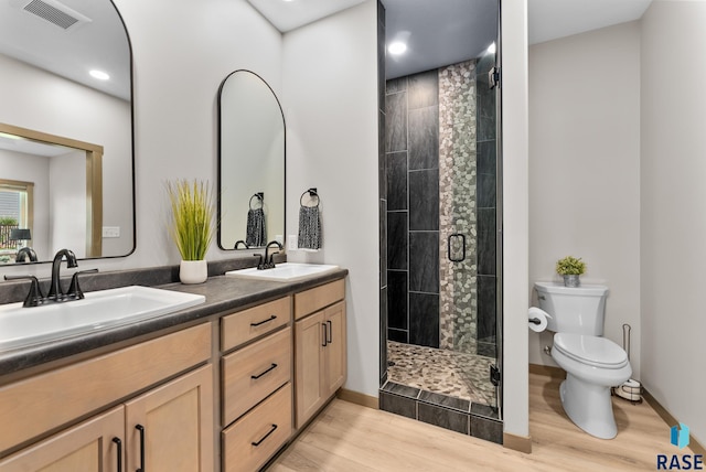 bathroom featuring vanity, walk in shower, toilet, and hardwood / wood-style flooring