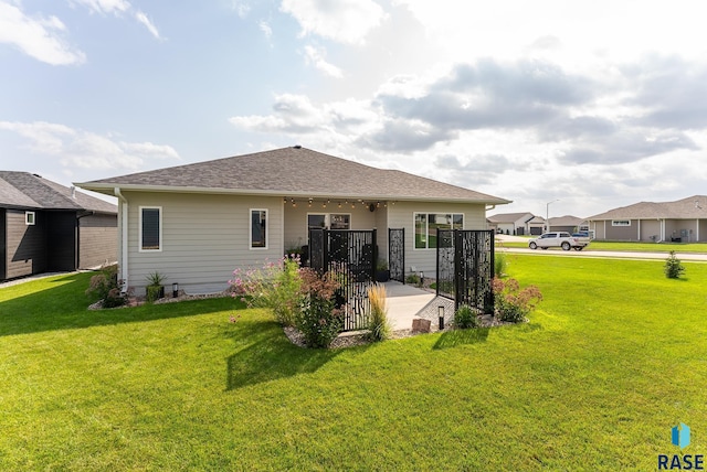 rear view of house featuring a lawn