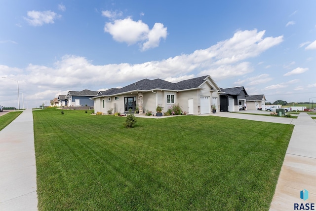 single story home with a garage and a front lawn