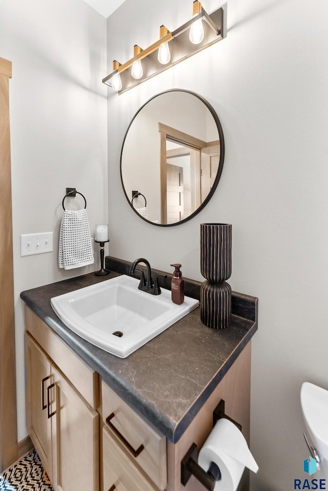 bathroom featuring vanity and toilet