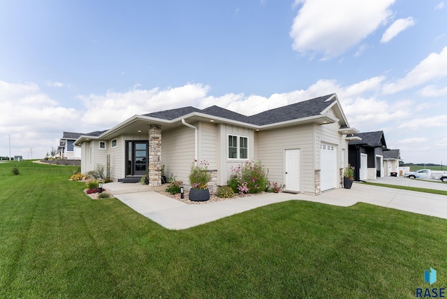 view of front of house with a garage and a front lawn