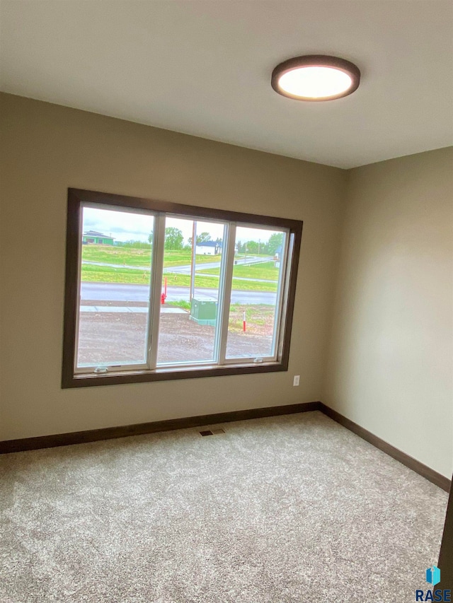 unfurnished room with carpet floors