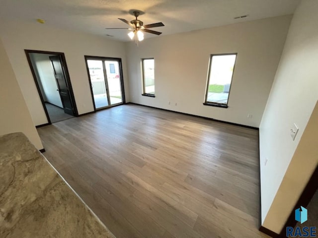 empty room featuring ceiling fan and light wood-type flooring