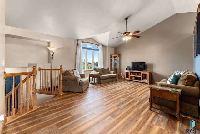 living room with vaulted ceiling, hardwood / wood-style flooring, and ceiling fan