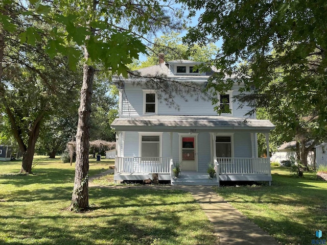 american foursquare style home with a porch and a front yard