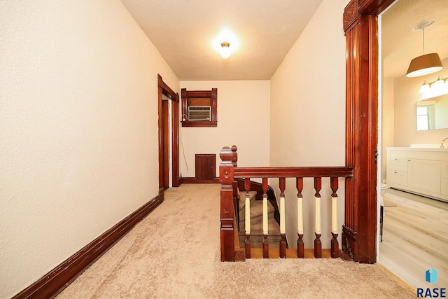 hall with baseboards and carpet floors