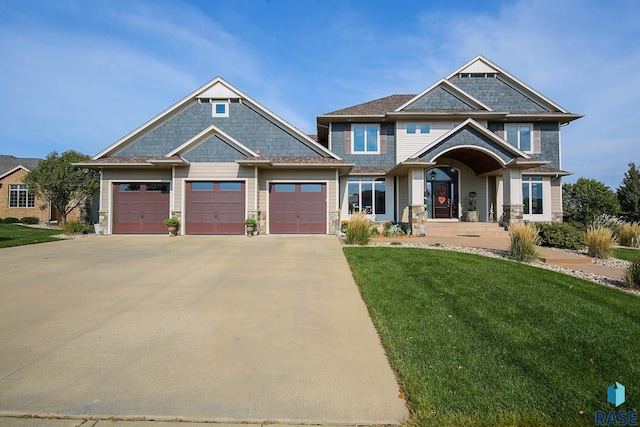 craftsman-style home with a front yard and a garage