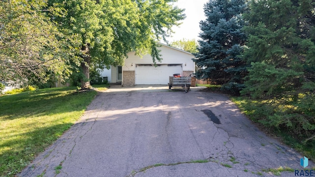 view of front of house featuring a garage and a front lawn