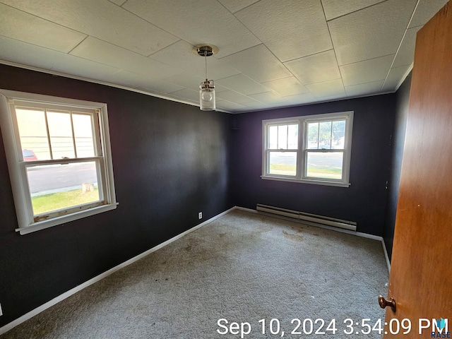 carpeted empty room with baseboard heating