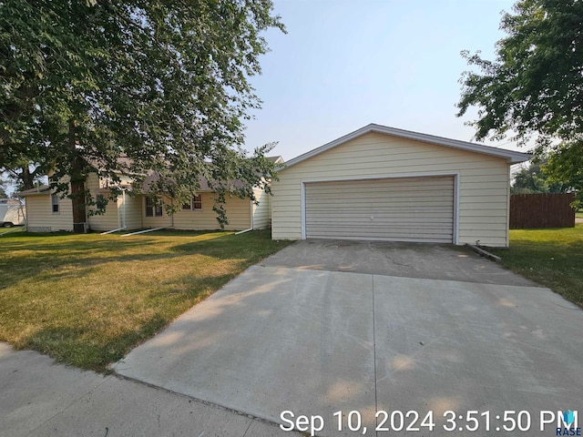 view of front of home with a front yard and a garage