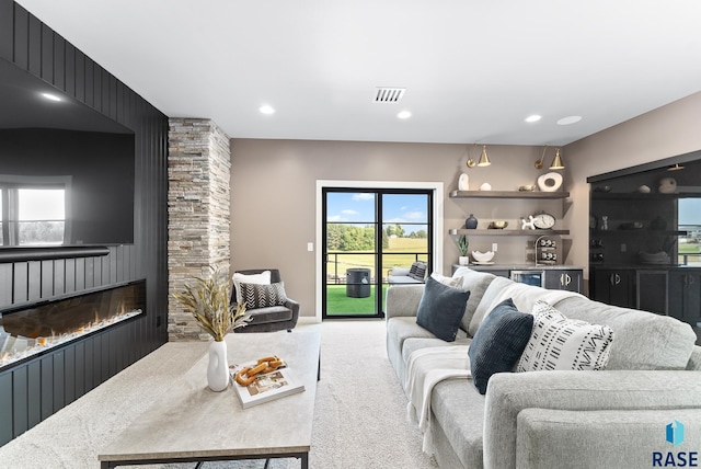 carpeted living room featuring a fireplace