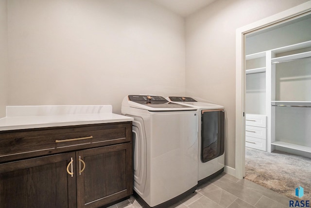 laundry area featuring cabinets and washing machine and dryer