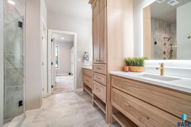 bathroom with vanity and a shower with shower door