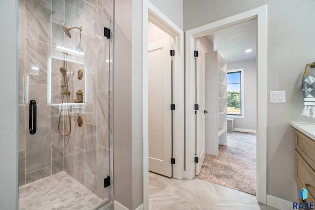 bathroom with walk in shower and vanity