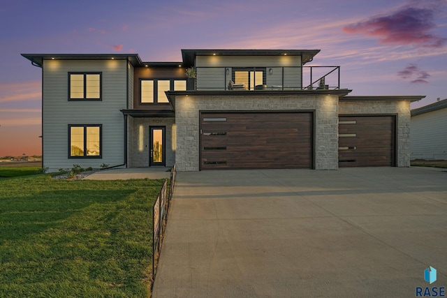 contemporary house with a garage and a yard