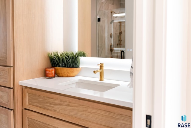 bathroom with an enclosed shower and vanity