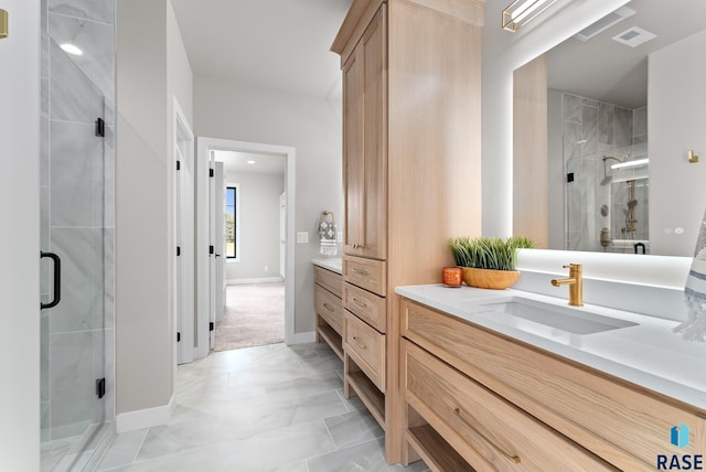 bathroom featuring vanity and an enclosed shower