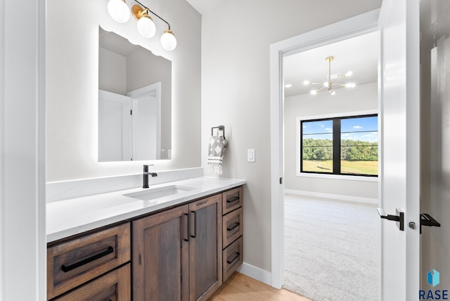 bathroom featuring vanity and a notable chandelier