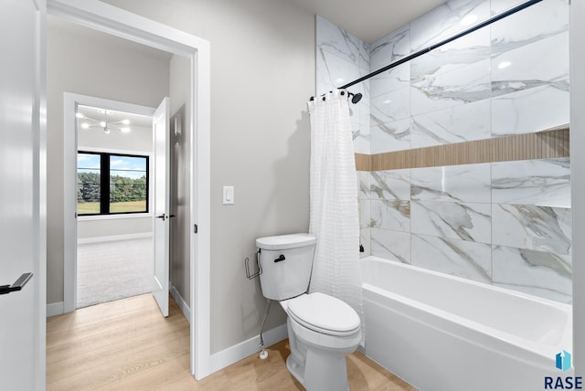 bathroom with shower / tub combo with curtain, hardwood / wood-style floors, and toilet